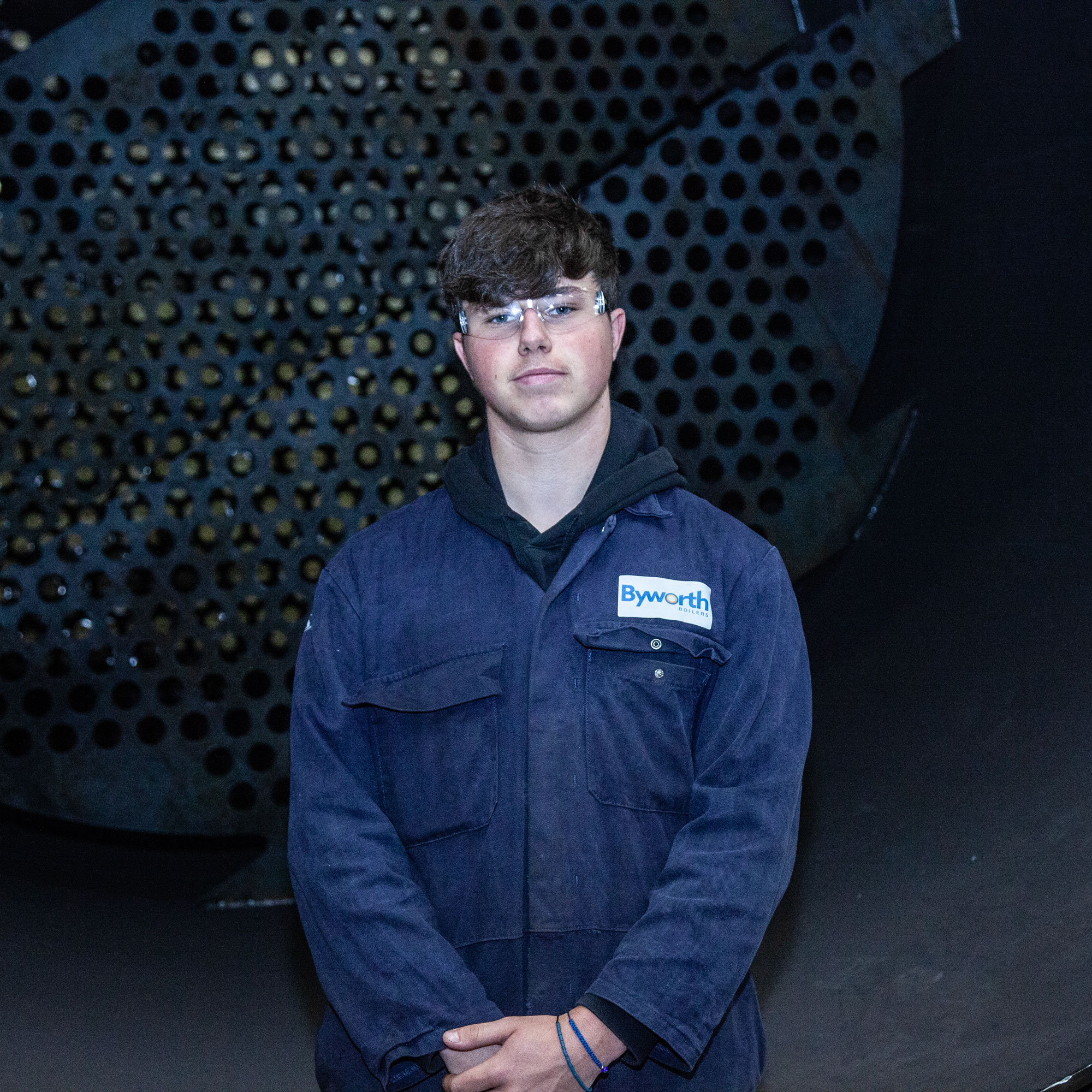 Apprentice in a boiler suit looking moody and cool 